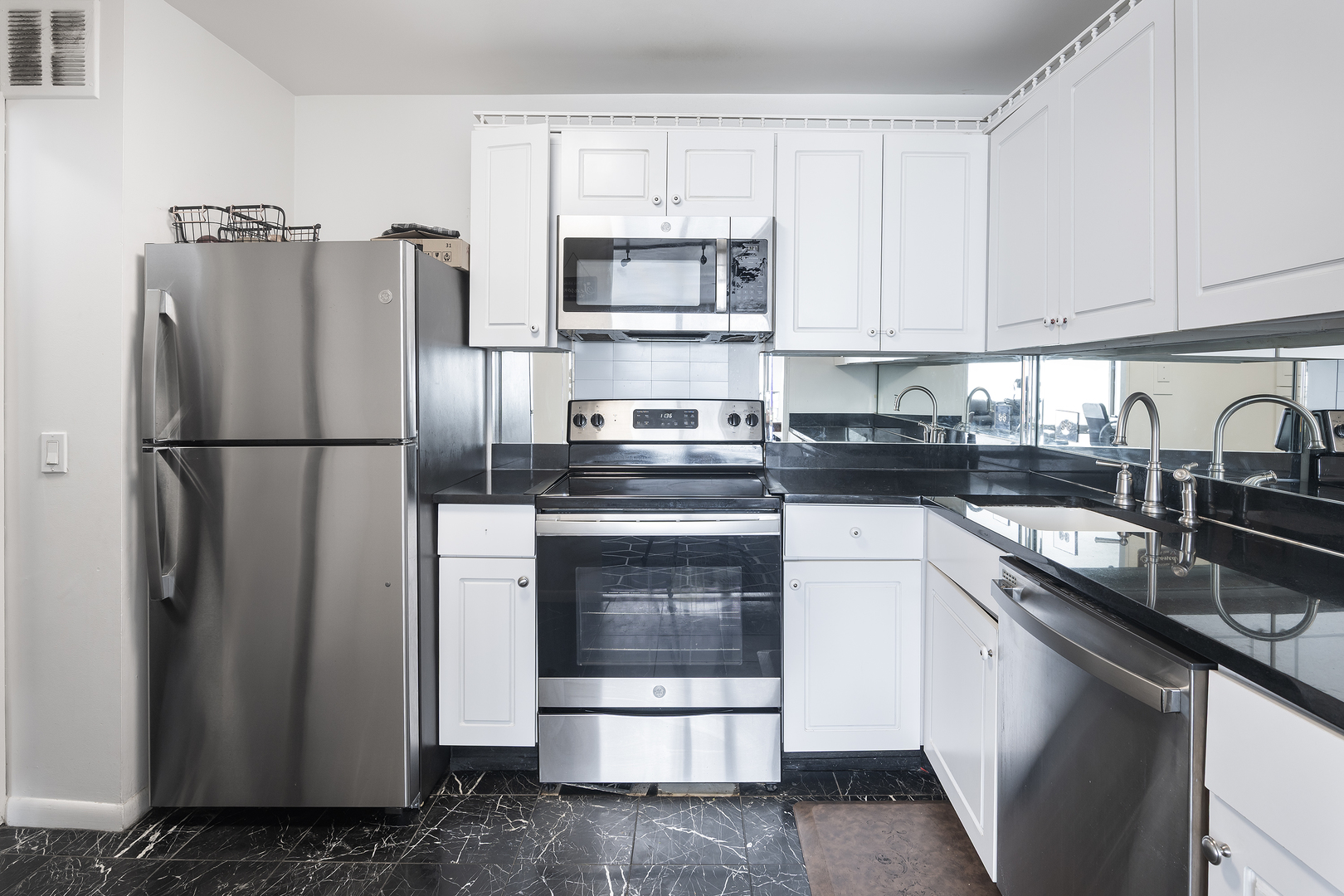 5445 North Sheridan Road, Unit 3210 Chicago, IL 60640 - Photo 8 of 14 a kitchen with a refrigerator sink and cabinets