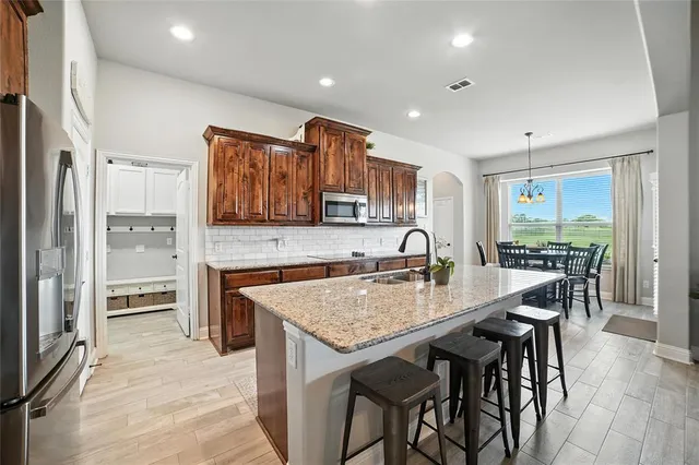 a kitchen with granite countertop counter space a sink appliances and cabinets