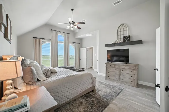 a bedroom with a bed and ceiling fan