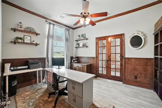 a kitchen with a stove a refrigerator and a dining table with wooden floor