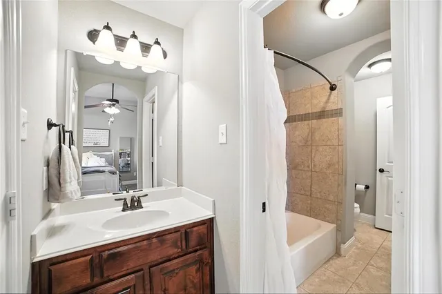a bathroom with a tub sink and mirror