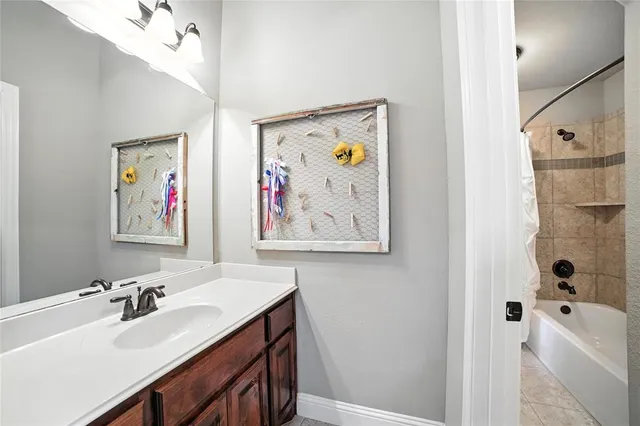 a bathroom with a tub sink and mirror