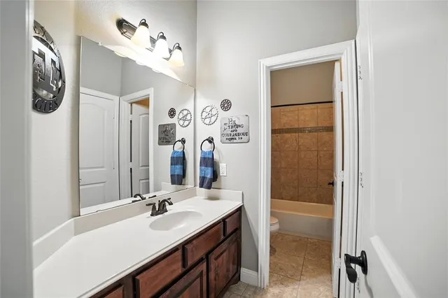 a bathroom with a sink vanity and a mirror