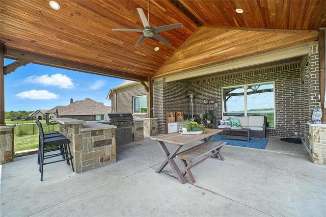 a work room with furniture and a large window