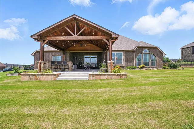 a view of a house with a big yard and potted plants