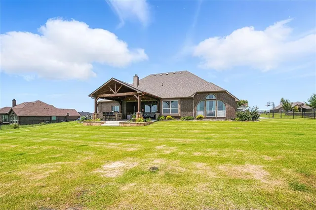 a front view of a house with a big yard