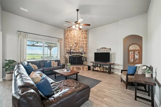 a living room with furniture a fireplace and a flat screen tv