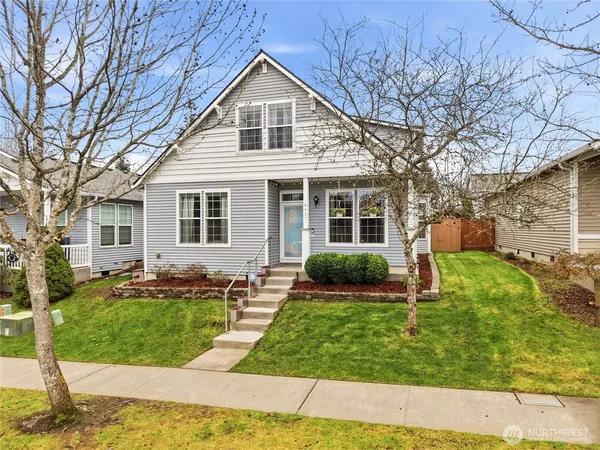 a front view of house with yard and green space