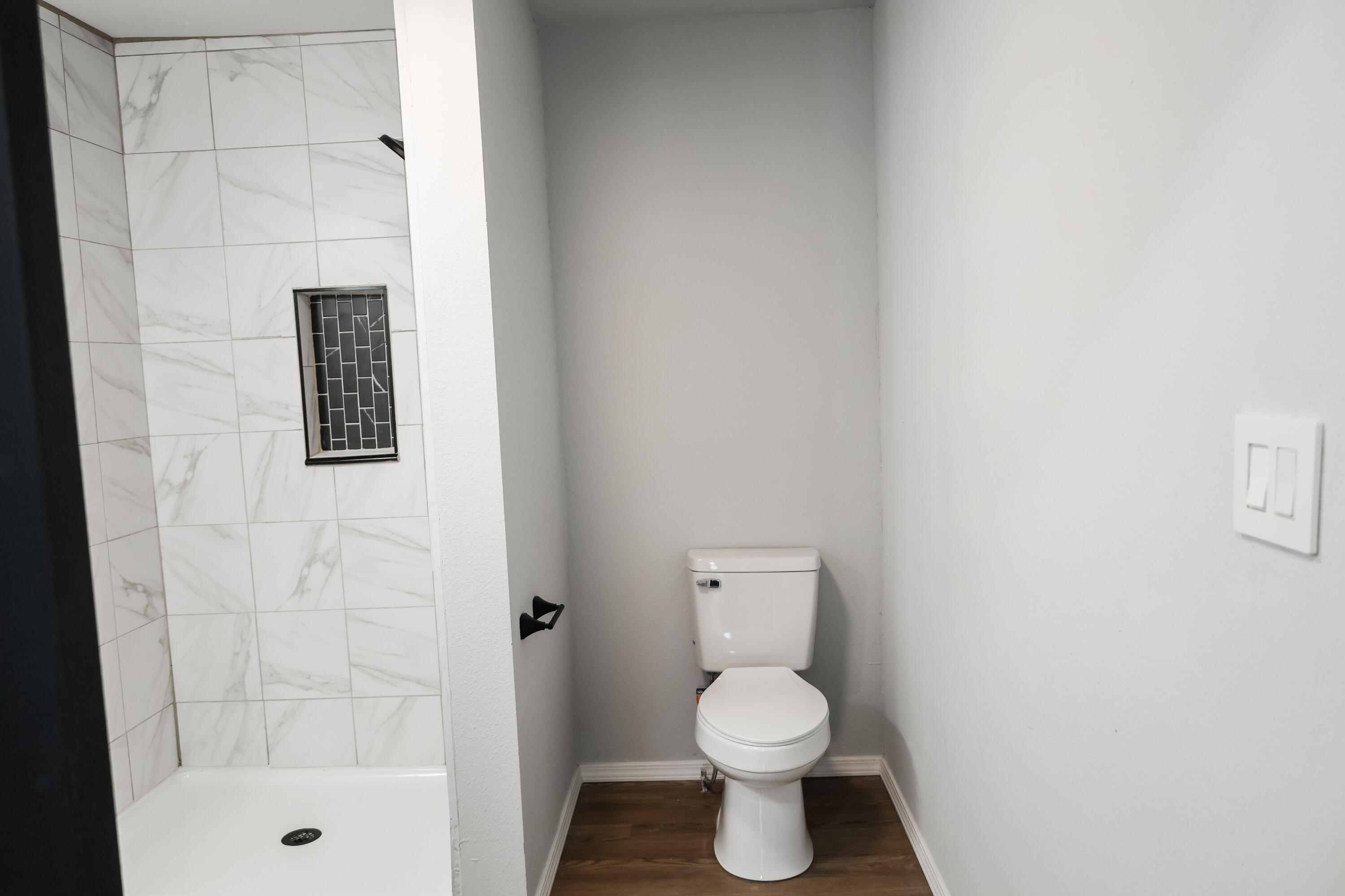 112 Southwest 8th Plainview, TX 79072 - Photo 13 of 24 a white toilet sitting next to a bathroom sink