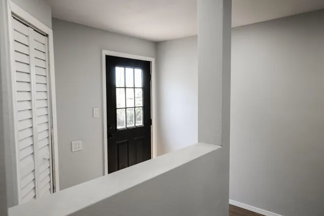 a view of an empty room with windows