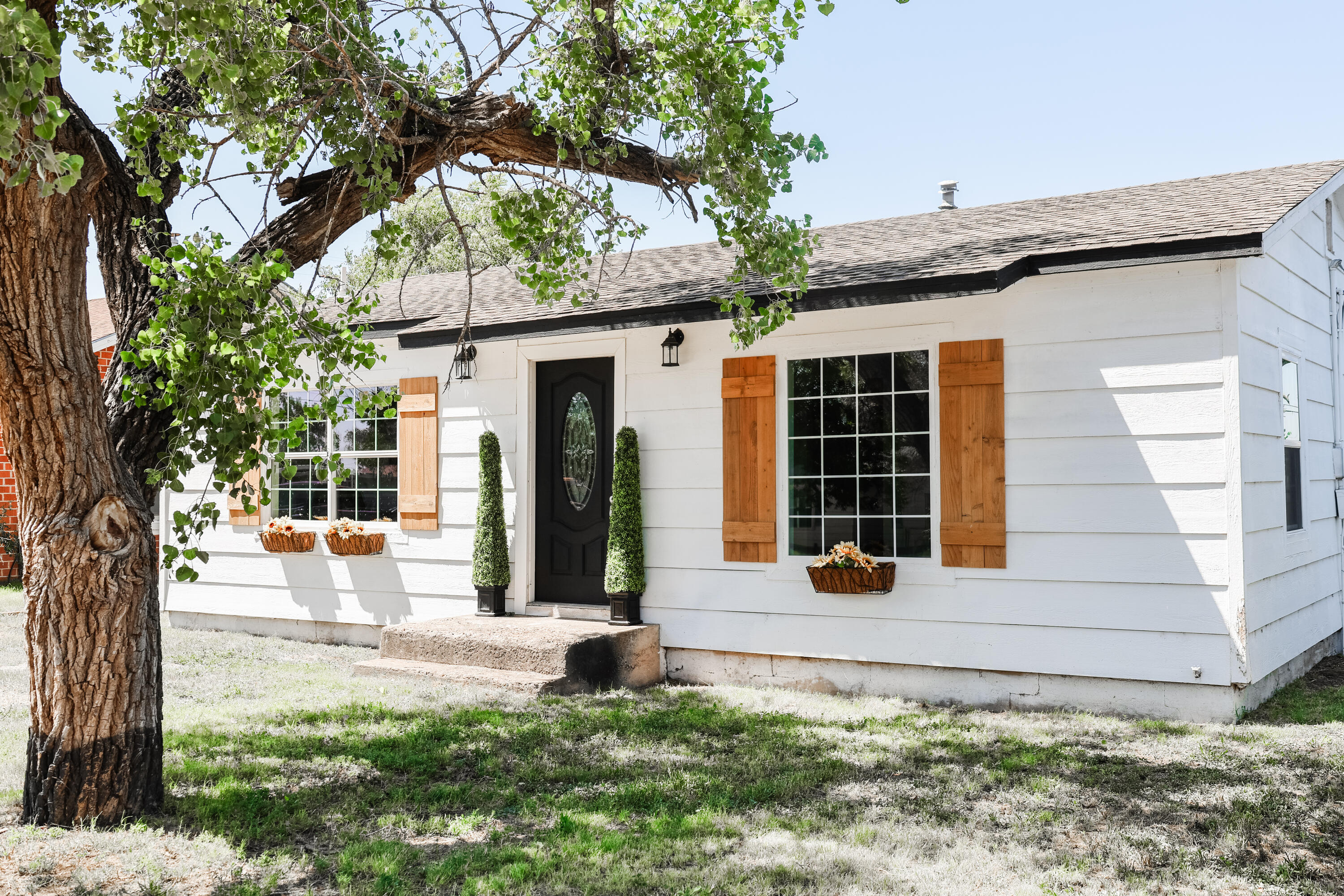 112 Southwest 8th Plainview, TX 79072 - Photo 2 of 24 a front view of a house with a large tree