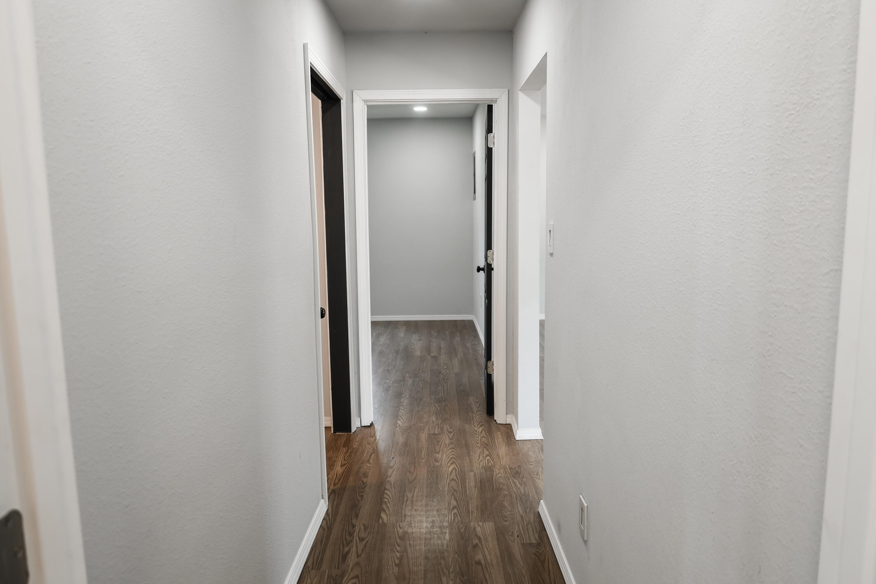 112 Southwest 8th Plainview, TX 79072 - Photo 10 of 24 a view of a hallway with wooden floor