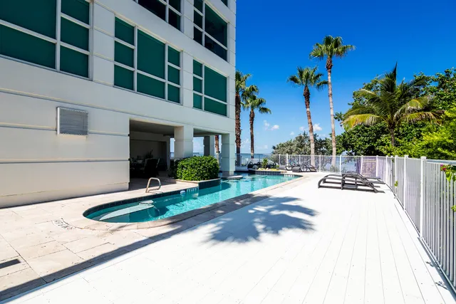 a view of a house with backyard sitting area and swimming pool
