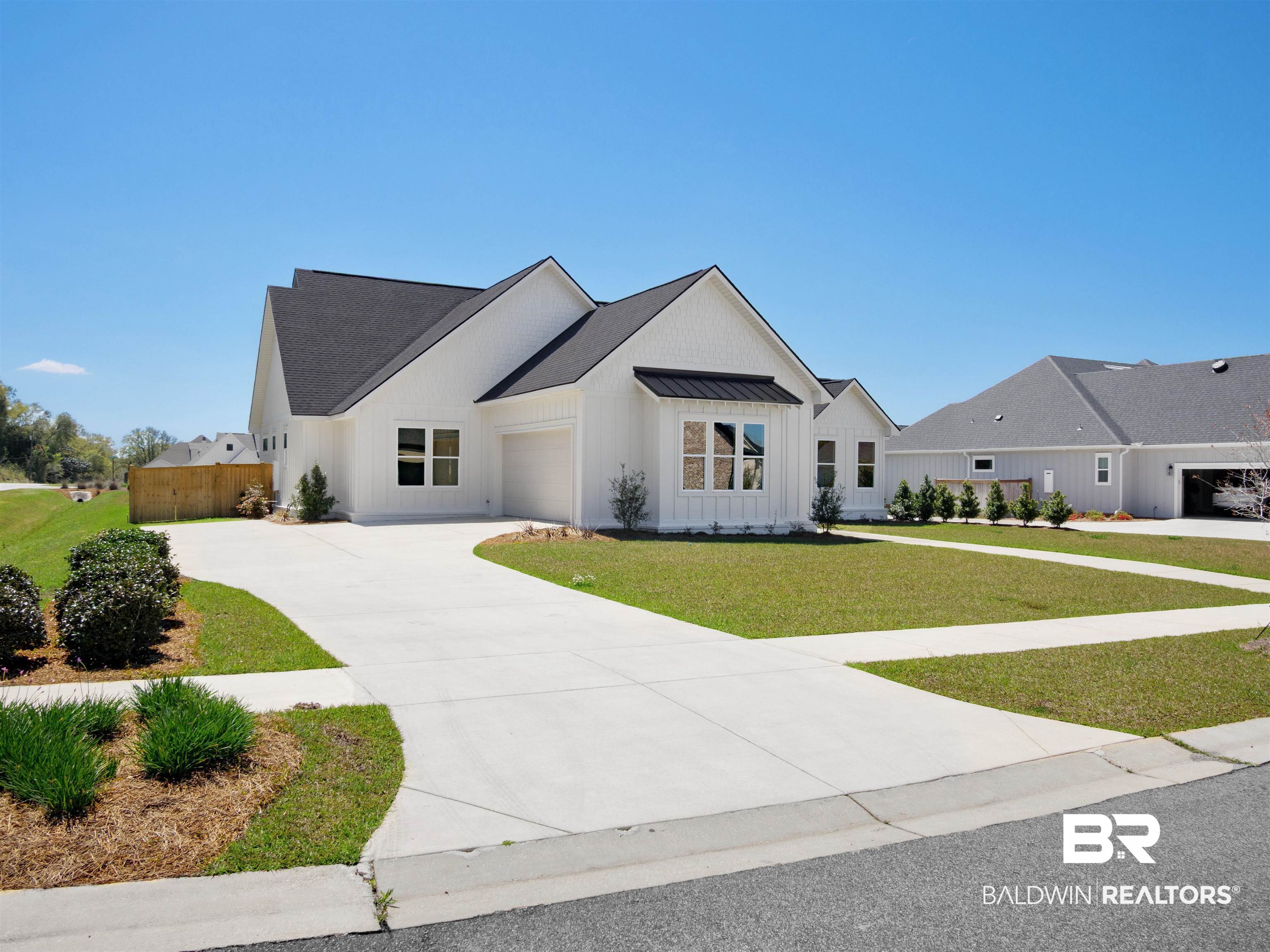 10970 Turin Avenue Fairhope, AL 36532 - Photo 50 of 61 Modern farmhouse with a garage, a standing seam roof, a front lawn, board and batten siding, and driveway