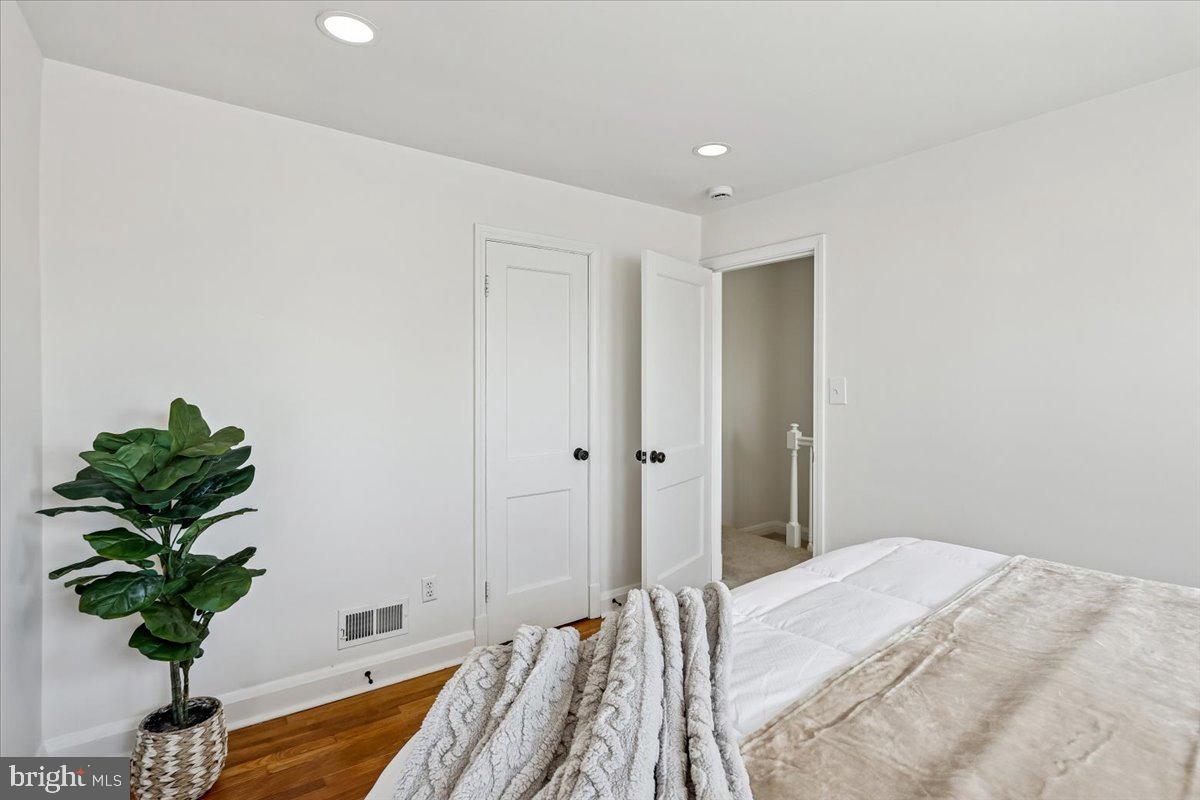1616 Hardwick Road Towson, MD 21286 - Photo 15 of 36 a bedroom with a bed and a potted plant