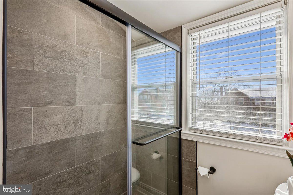 1616 Hardwick Road Towson, MD 21286 - Photo 17 of 36 a bathroom with a window and a shower