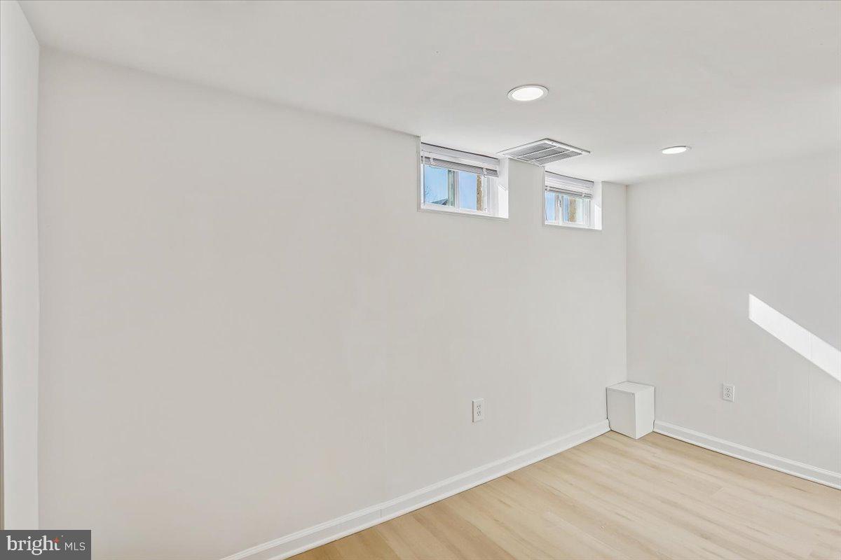 1616 Hardwick Road Towson, MD 21286 - Photo 27 of 36 a view of an empty room with wooden floor and a window