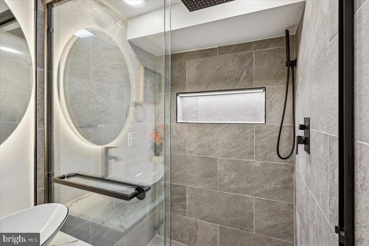 1616 Hardwick Road Towson, MD 21286 - Photo 31 of 36 a bathroom with a mirror and a shower