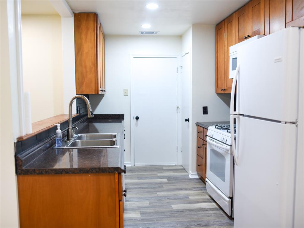 2325 North Ricketts Street Sherman, TX 75092 - Photo 11 of 28 a kitchen with a refrigerator and a sink