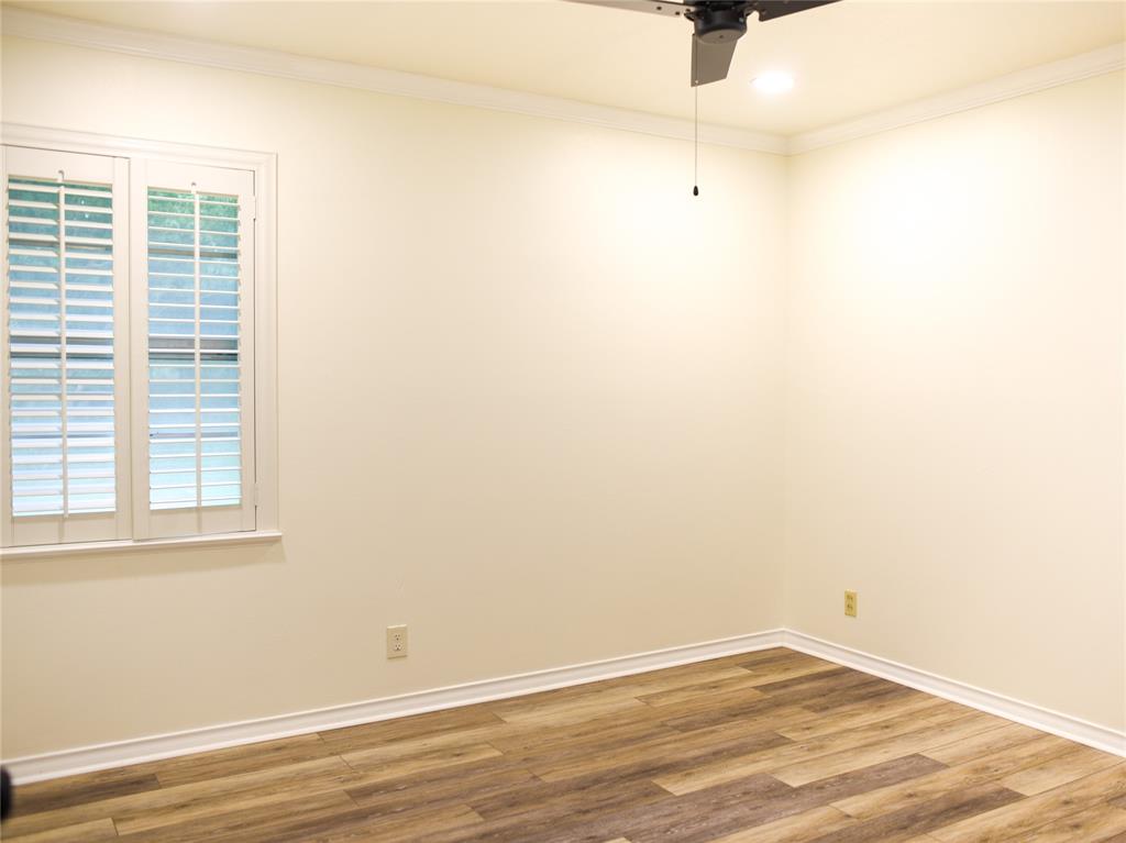 2325 North Ricketts Street Sherman, TX 75092 - Photo 16 of 28 an empty room with wooden floor and windows