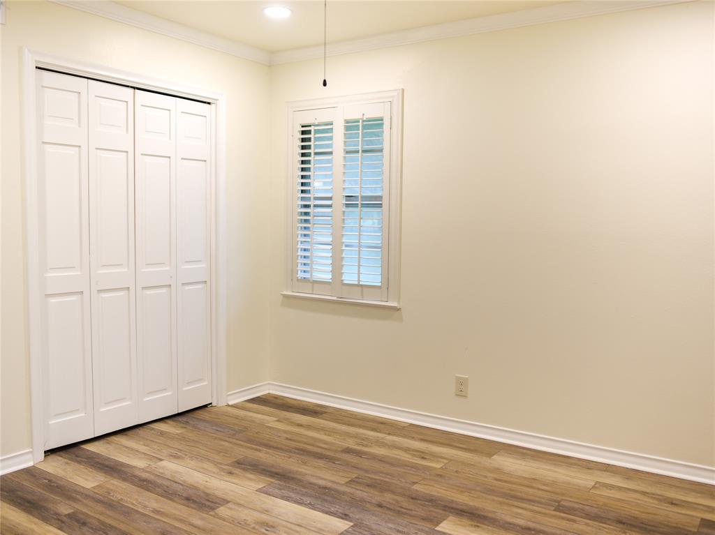 2325 North Ricketts Street Sherman, TX 75092 - Photo 17 of 28 an empty room with wooden floor and windows