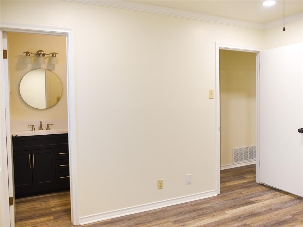 2325 North Ricketts Street Sherman, TX 75092 - Photo 18 of 28 a bathroom with a sink and a mirror