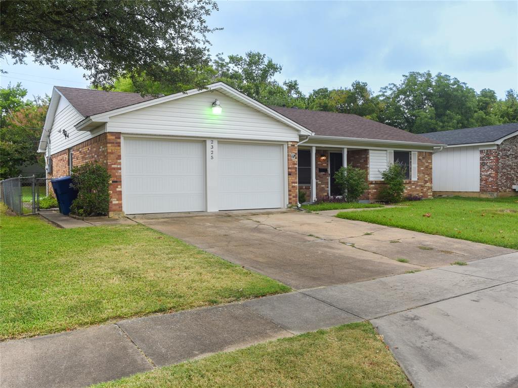 2325 North Ricketts Street Sherman, TX 75092 - Photo 2 of 28 a front view of a house with a yard and garage
