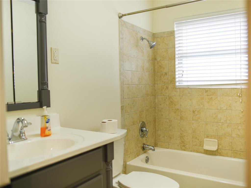 2325 North Ricketts Street Sherman, TX 75092 - Photo 22 of 28 a bathroom with a sink a toilet and shower