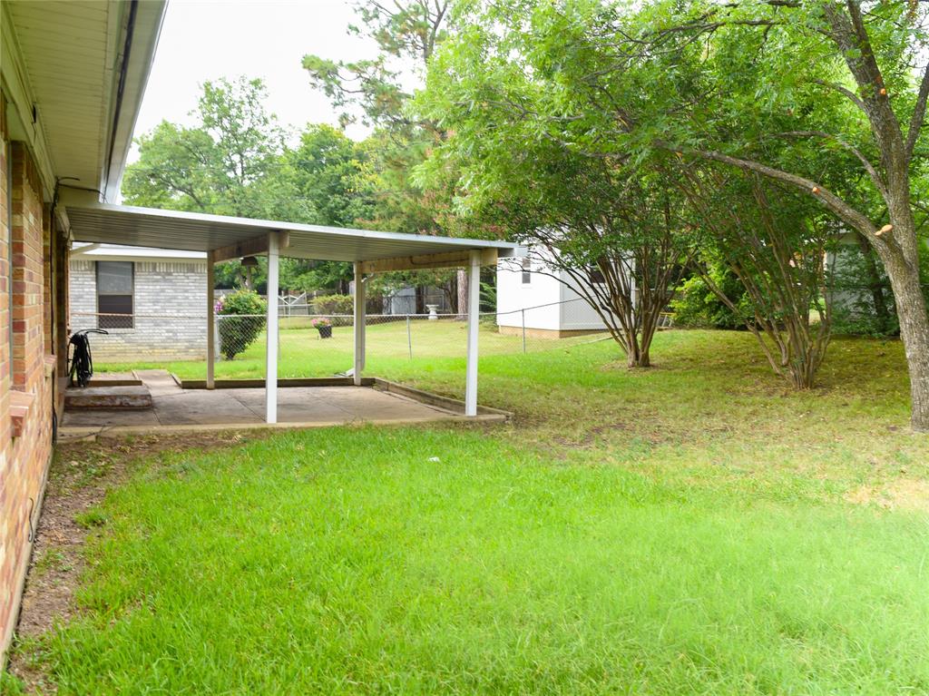 2325 North Ricketts Street Sherman, TX 75092 - Photo 26 of 28 a view of a house with backyard and a tree