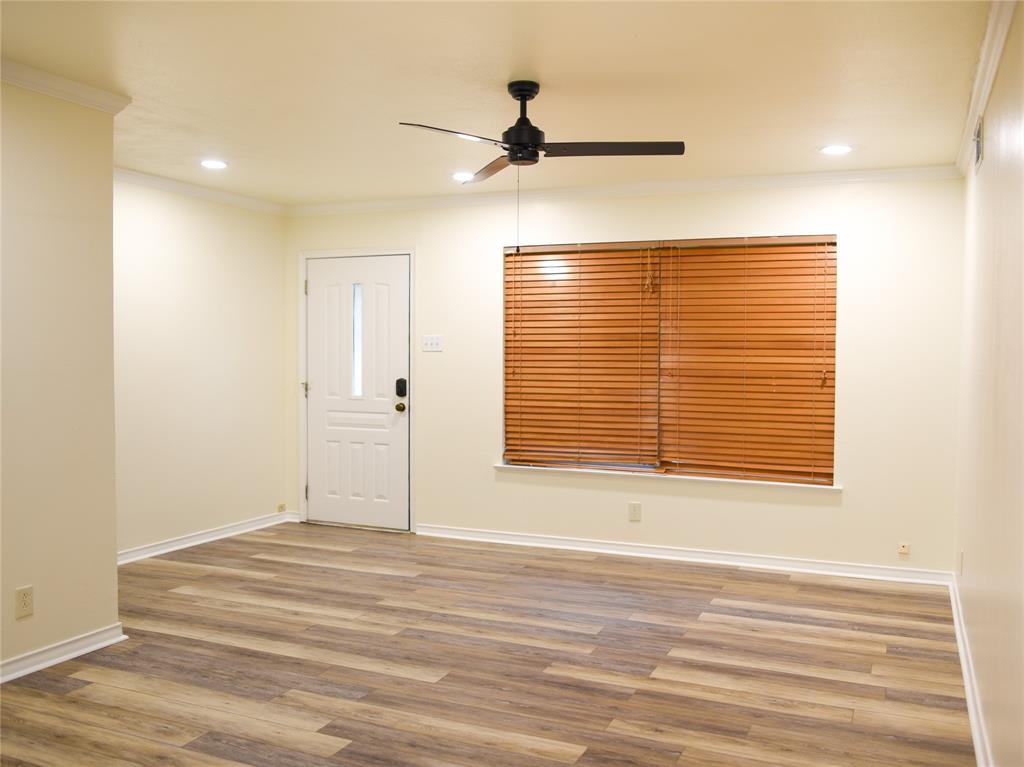 2325 North Ricketts Street Sherman, TX 75092 - Photo 5 of 28 a view of a room with a ceiling fan and wooden floor