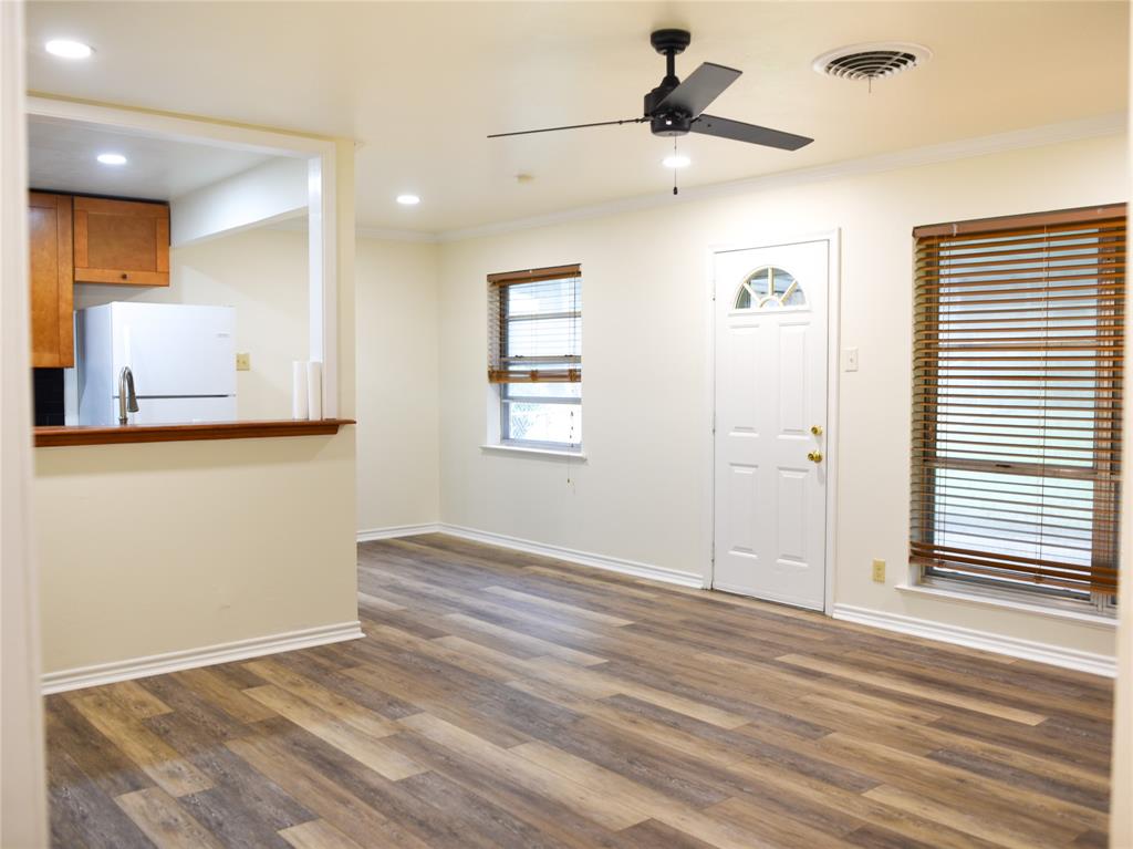 2325 North Ricketts Street Sherman, TX 75092 - Photo 8 of 28 an empty room with wooden floor and windows
