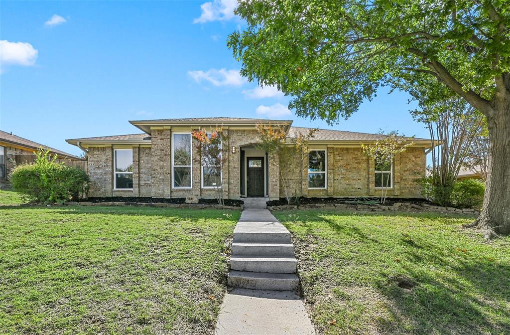 1221 Elder Carrollton, TX 75007 - Photo 1 of 1 a front view of a house with a yard
