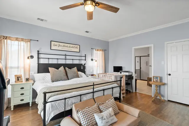 a bedroom with a bed and a chandelier