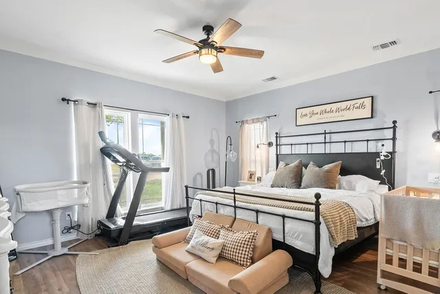 a bedroom with a bed and a chandelier