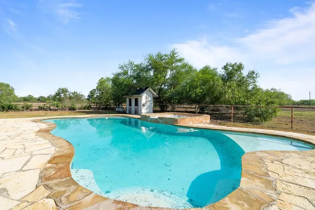 a view of a swimming pool with an outdoor space and seating area