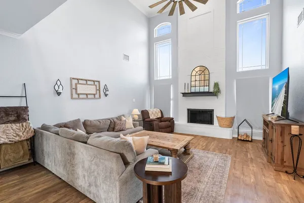 a living room with furniture a fireplace and a flat screen tv