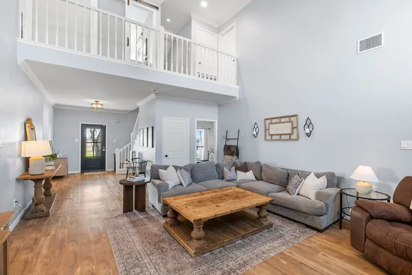 a living room with furniture a rug and a chandelier