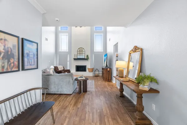 a living room with furniture and wooden floor