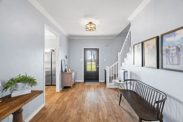a view of an entryway with wooden floor and a livingroom