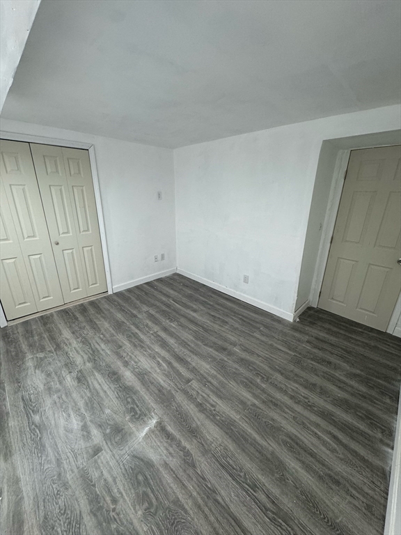 244 Wilbur Street, Unit 3 Fall River, MA 02724 - Photo 12 of 21 a view of an empty room with wooden floor and closet