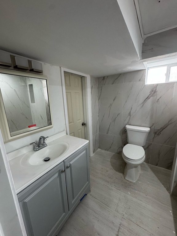 244 Wilbur Street, Unit 3 Fall River, MA 02724 - Photo 15 of 21 a bathroom with a toilet sink and mirror