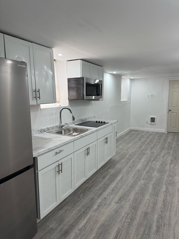 244 Wilbur Street, Unit 3 Fall River, MA 02724 - Photo 2 of 21 a large white kitchen with stainless steel appliances granite countertop a stove a sink and a refrigerator