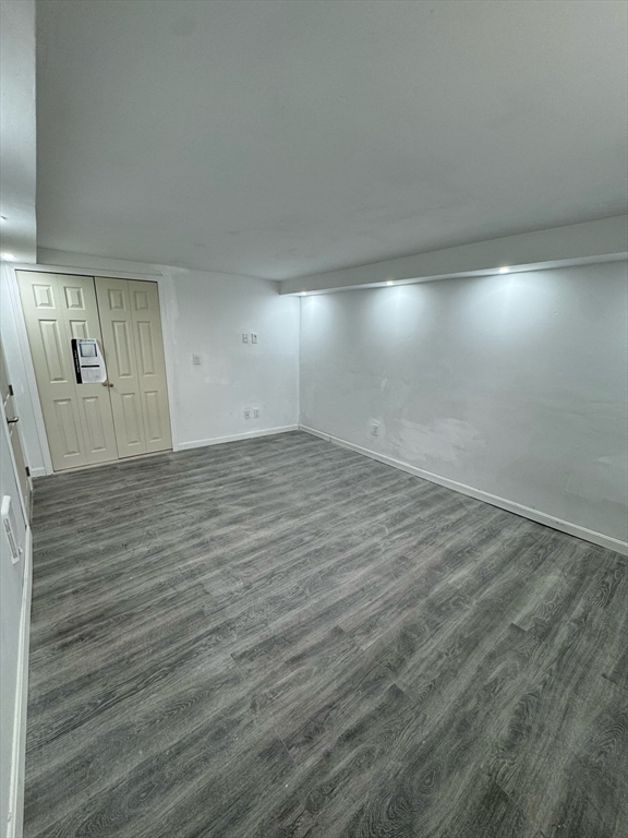 244 Wilbur Street, Unit 3 Fall River, MA 02724 - Photo 21 of 21 an empty room with wooden floor and windows