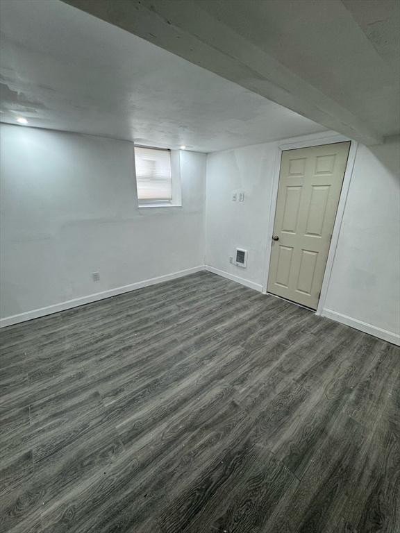 244 Wilbur Street, Unit 3 Fall River, MA 02724 - Photo 10 of 21 an empty room with wooden floor and windows
