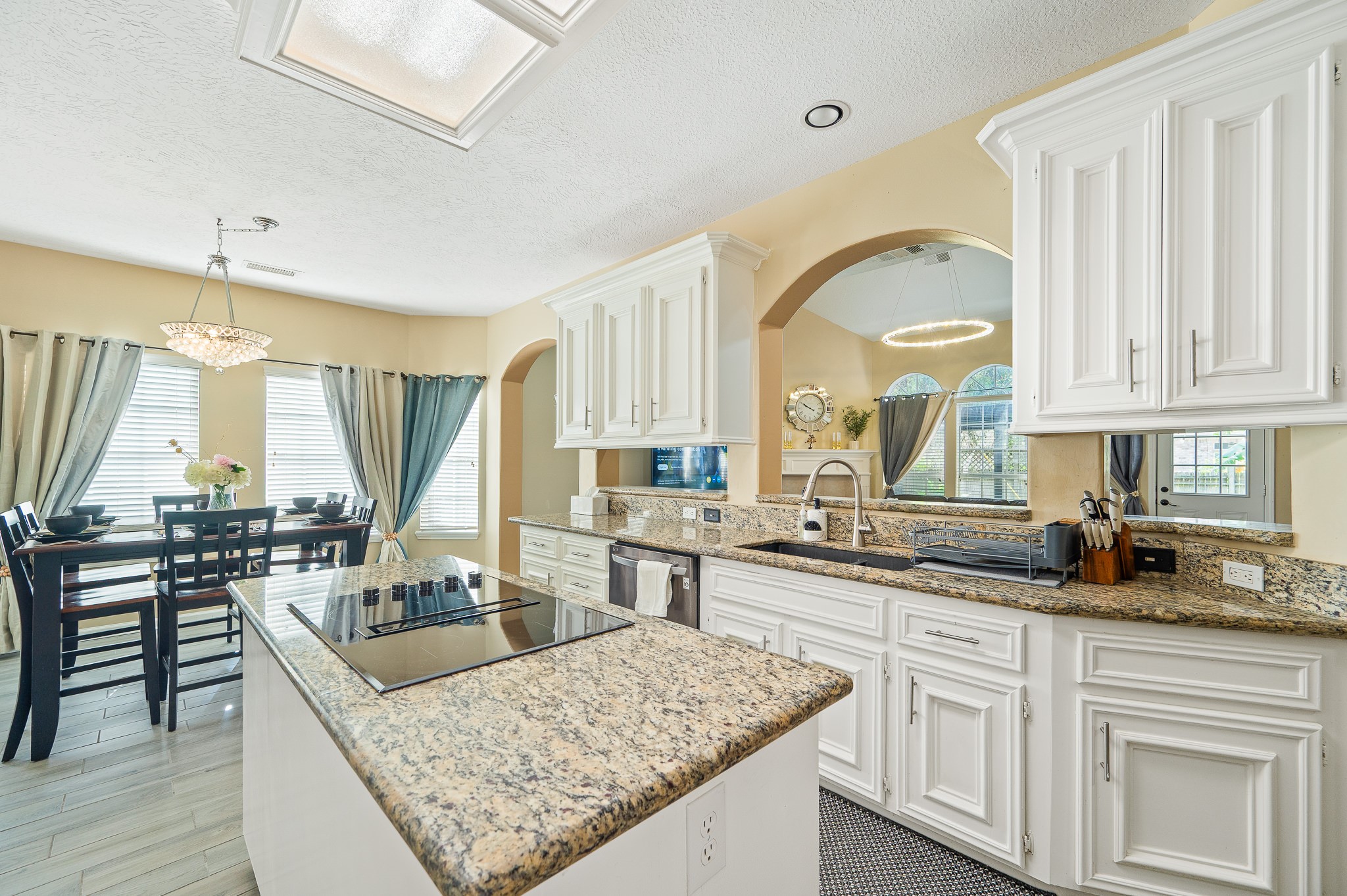 8111 Morningbrook Court Spring, TX 77379 - Photo 12 of 46 a kitchen with stainless steel appliances granite countertop a sink a stove and a wooden cabinets
