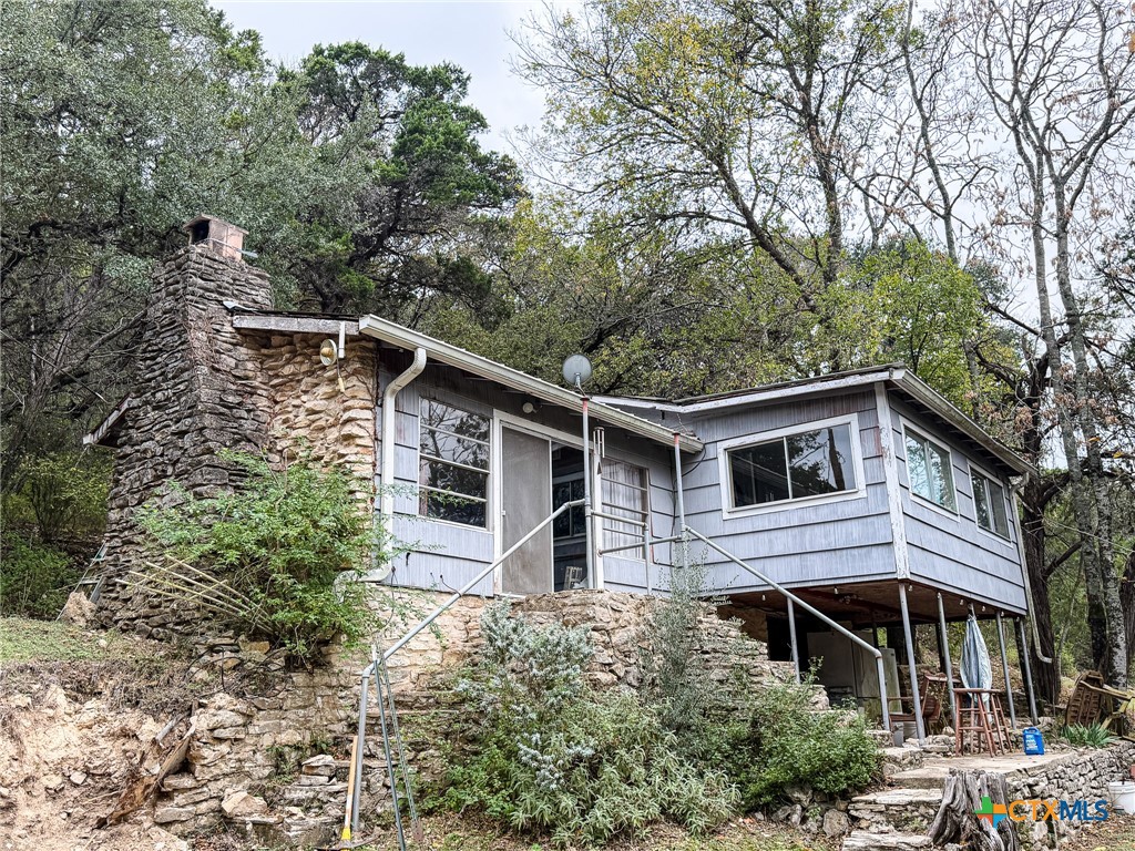 9751 River Road New Braunfels, TX 78132 - Photo 8 of 12 a front view of a house with a garden