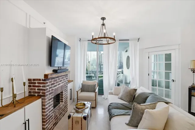 a living room with furniture a flat screen tv and a window