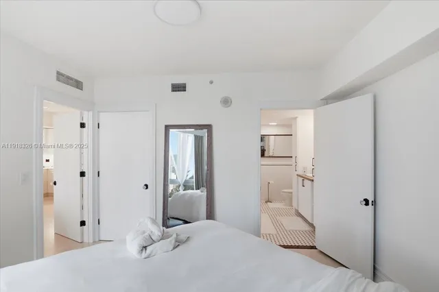 a bedroom with a bed and a view of bathroom