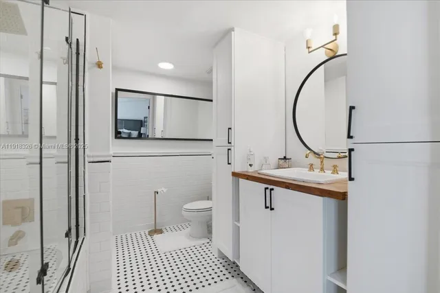 a bathroom with a sink a toilet and a mirror