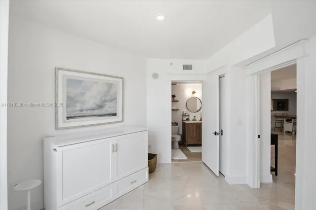 a hallway with closet and mirror